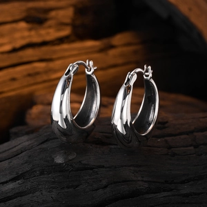 Minimalist geometric U-shaped 925 sterling silver hoop earrings on dark wood base