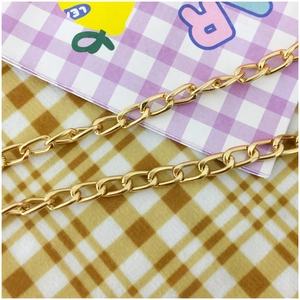Close-up of high-shine gold metal chain strap for cute shiba inu dog crossbody bag