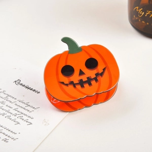 Pince à cheveux citrouille d'Halloween orange avec visage noir sur carte décorative