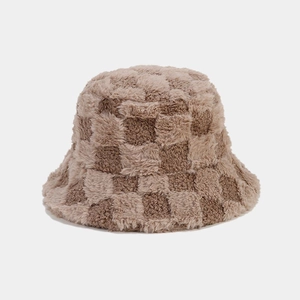 Detail of checkered plush bucket hat showing thick faux fur texture and brown grid pattern