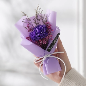 Close-up of handmade purple mini dried flower bouquet with Best Wishes gift tag