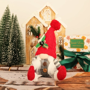 Nordic Christmas gnome plush with red knit hat and grey plaid outfit in a festive setting