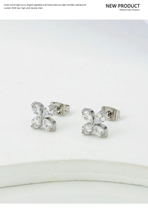 Detailed macro view of silver clover stud earrings featuring sparkling zircon petal settings