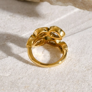 Detailed back view of gold-plated stainless steel hollow leaf ring with zircon stones