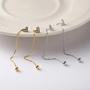 Asymmetrical heart drop earrings in gold and silver with zircon stones and long chain