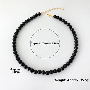 Detail of 0.8cm black onyx beads necklace with 42cm length and 5.5cm gold extender chain