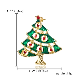 Detail of Christmas tree brooch with green enamel, gold finish and red rhinestones
