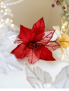 Close-up of red mesh poinsettia with glitter petals and festive bokeh background