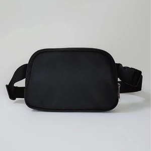 Minimalist black waterproof nylon waist bag with adjustable strap and buckle closure