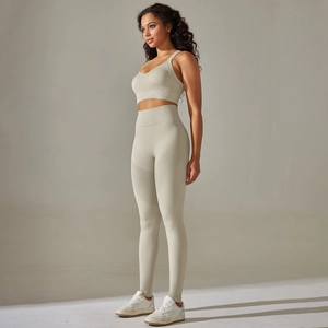 Detail of light grey seamless ribbed yoga set showing cross back bra and high waist leggings