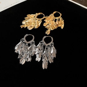 Detailed view of leaf fringe earrings with gold and silver polished metal layers