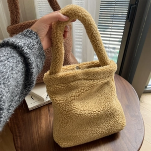 Detailed close-up of fluffy teddy fleece mini tote bag with metal magnetic closure