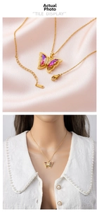Detail of pink butterfly pendant on gold titanium steel chain shown on satin and model