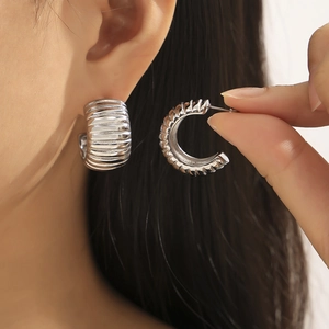 Elegant C-shaped hollow striped hoop earrings in polished silver finish for women