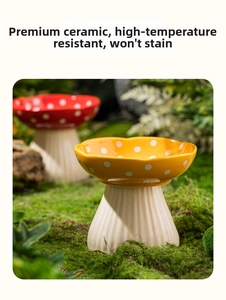 Detail of mushroom-shaped ceramic cat bowl with elevated base on green moss surface