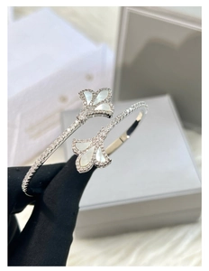 Detailed view of the fan-shaped 18k gold plated bracelet with pave zircons and white mother of pearl