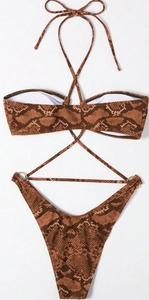 Detail of snake print bikini top with criss-cross halter straps and golden ring accents