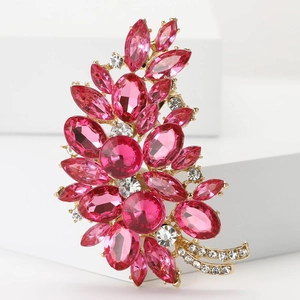 Macro detail of high-grade alloy floral brooch with pink crystals and small white diamonds