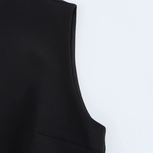 Close-up of the black sleeveless dress neckline with high-quality woven fabric texture