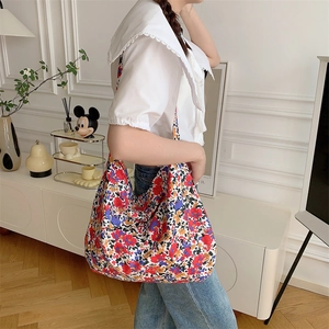 Detailed shot of oversized leopard floral tote bag on model for size perspective