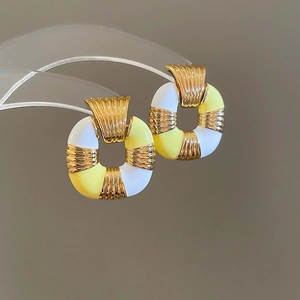 Vintage style gold earrings with white and yellow enamel in retro rectangle design
