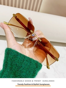 Detailed macro view of rimless square sunglasses featuring wood grain temples and gradient lens