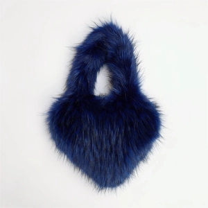 Detail showing the soft texture of a dark blue faux fur heart-shaped shell handbag
