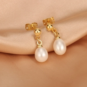 Detailed close-up of 18K gold plated drop earrings featuring elegant white freshwater pearls