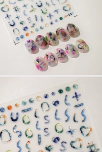 Macro shot of 3D colorful abstract ink splash and geometric symbols nail art stickers