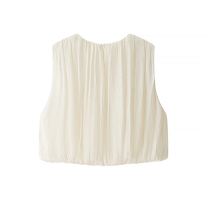 Detail view of cream sleeveless top featuring fine vertical pleats and back button closure