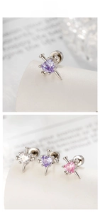 Detail of heart-shaped zircon earrings with punk style spike metal frame in three colors