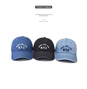 Detailed view of three washed denim baseball caps with NYC embroidery in assorted colors