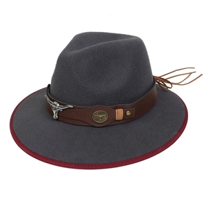 Detail of grey western cowboy hat with brown leather band and bull head metal ornament