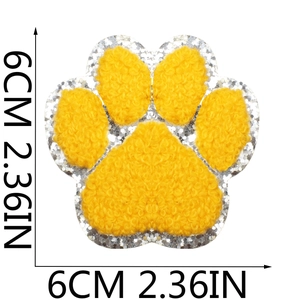 Detail of 6cm yellow chenille dog paw embroidery patch with silver glitter border