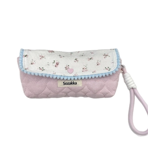 Floral pencil case with heart quilting, purple fabric, and cute pom-pom trim detail
