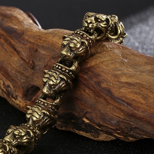 Macro detail of retro bronze tiger head links on a rugged stainless steel men's bracelet