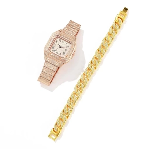 Close-up of rose gold square quartz watch and gold cuban chain bracelet with pavé diamonds