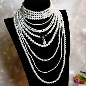 Elegant multi-layer baroque pearl necklace with silver clasp on a black bust display