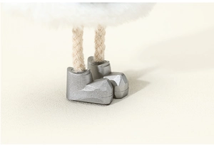 Macro detail of plush angel ornament showing woven rope legs and silver textured boots