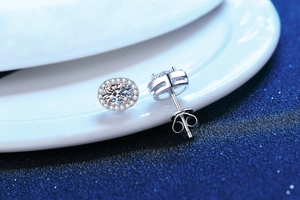 Macro detail of oval moissanite earrings with halo diamonds and S925 silver setting