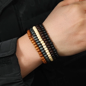 Detail of multi-layer handmade wooden beads stretch bracelets on a model's wrist