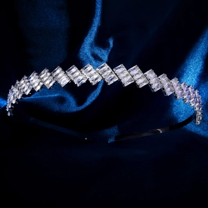 Close-up of sparkling silver headband with rectangular zircons on blue satin
