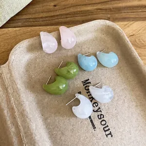 Set of four pastel resin crescent stud earrings in pink, blue, green, and marble white