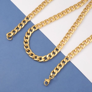 Detail of a golden Cuban link chain with lobster clasp on a blue and white background