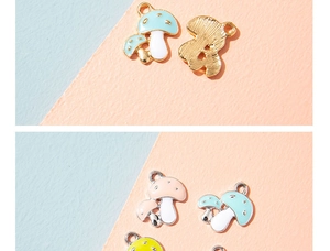Detail of colorful enamel mushroom charms with gold and silver metal edges for DIY jewelry