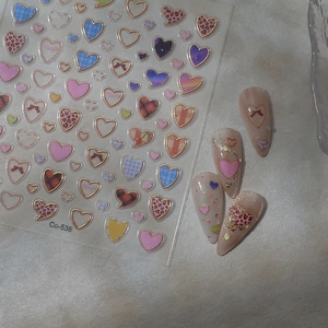 Macro shot of pink leopard and plaid heart nail stickers with gold foil details (Co-538)