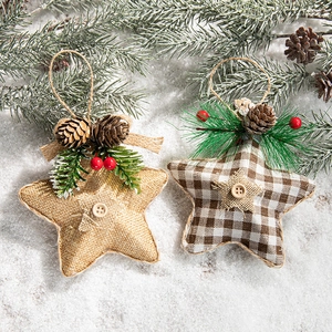 Linen and plaid star ornaments with pine cones and red berries on faux snow