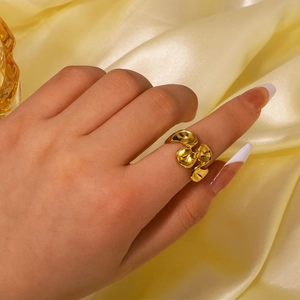 Minimalist gold geometric wave ring for women with an organic lava design on finger
