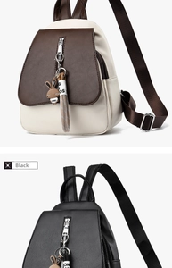 Close-up of stylish faux leather backpacks featuring cute rabbit charms and zippers