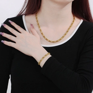 Golden Figaro chain necklace and bracelet set for men and women on model